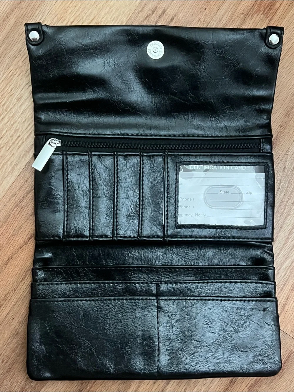 Black Fold-Over Clutch Wallet new without tags. Never used. Genuine leather